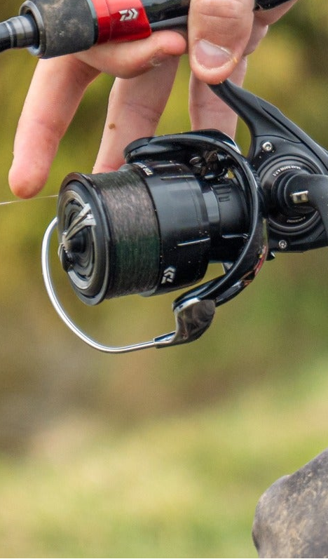 Close-up of a fishing rod handle with spinning reel, showcasing detailed craftsmanship and fishing line.