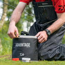 Хладилна чанта Daiwa ADVANTAGE BAITS ROUND COOL BAG в ръцете на рибар, готова за използване на риболов.