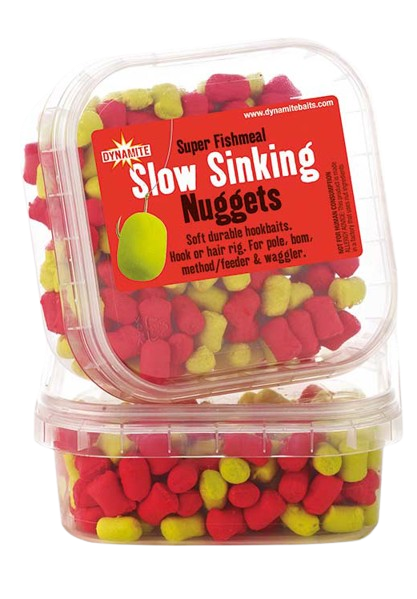 Дъмбели Dynamite Baits Super Fishmeal Slow Sinking Nuggets в опаковка с червени и жълти стръвни топчета.